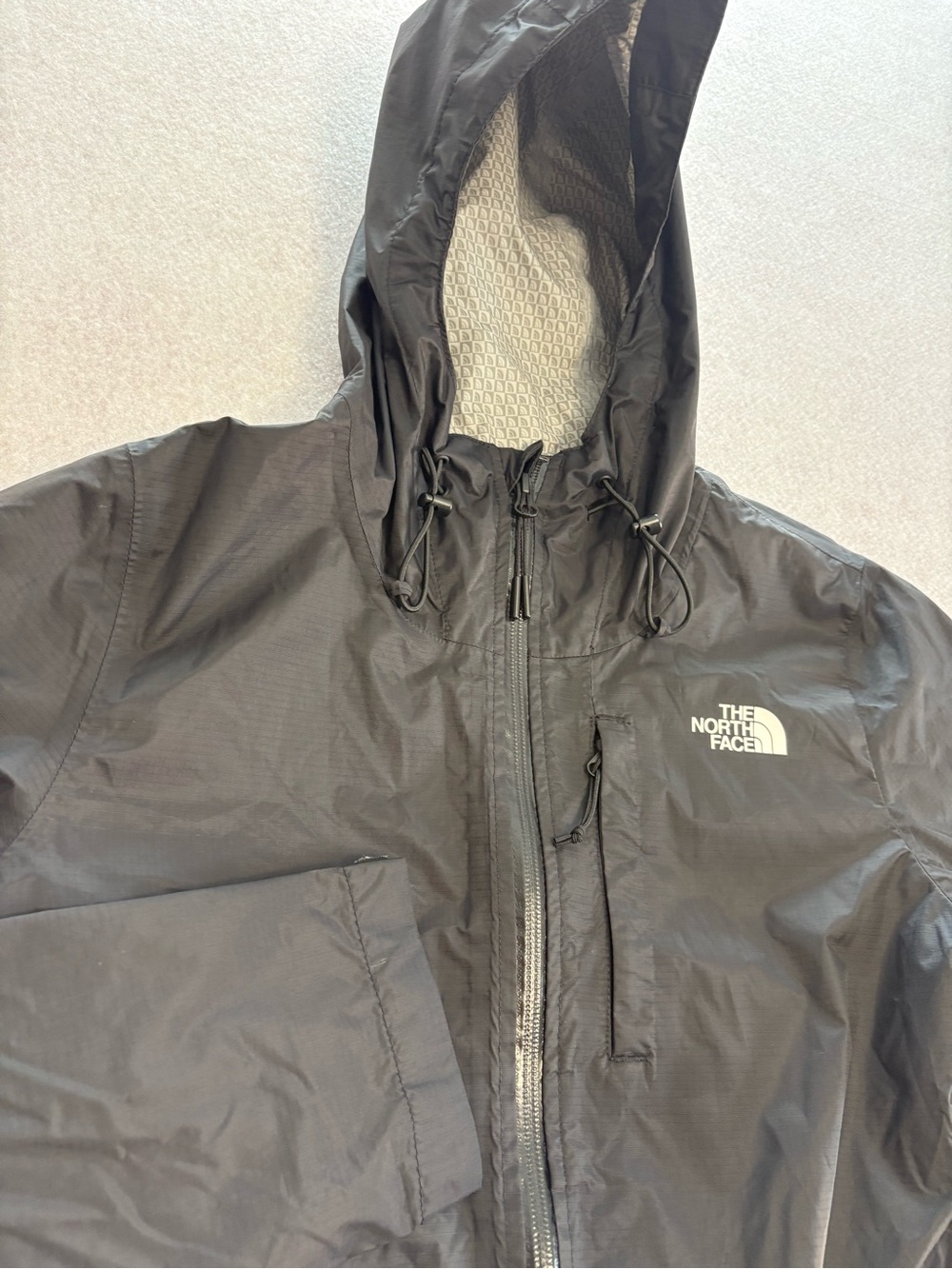 The North Face women’s Black Hooded Rain Jacket with Logo